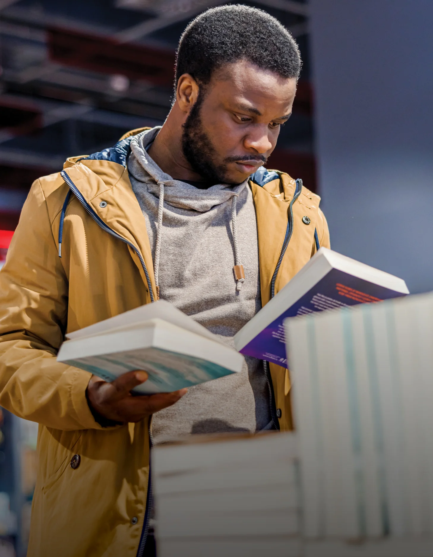 Photograph of a man looking at some books