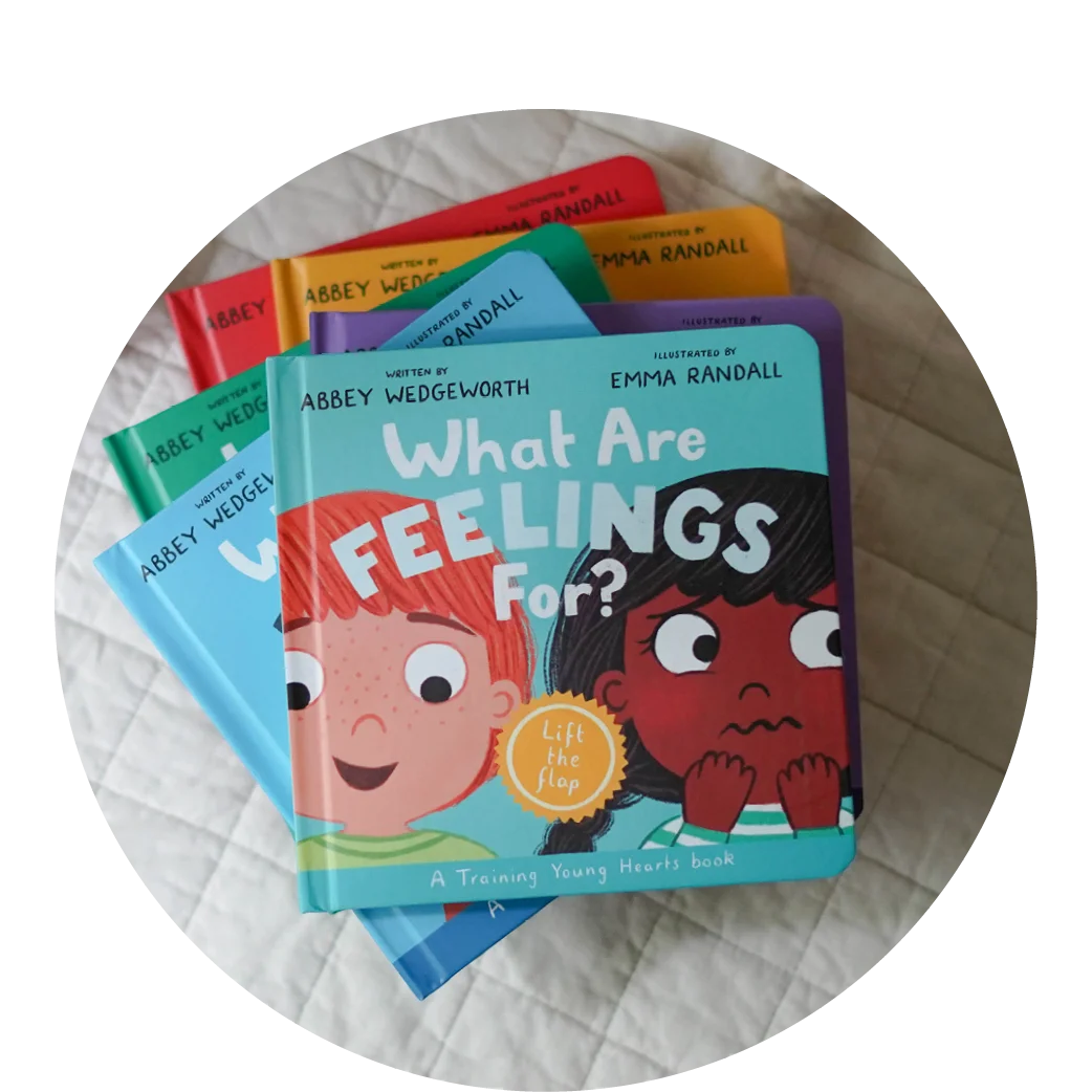 photograph of What Are Feelings For? on a stack of other board books in the Training Young Hearts Series
