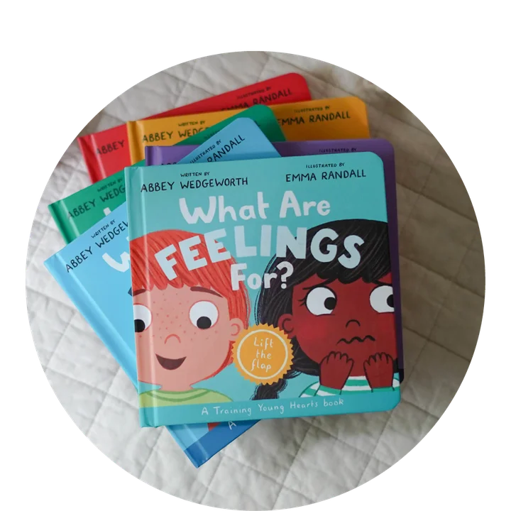 photograph of What Are Feelings For? on a stack of other board books in the Training Young Hearts Series