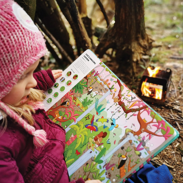 Photograph of little girl reading Seek and Find: Old Testament, illustration of creation