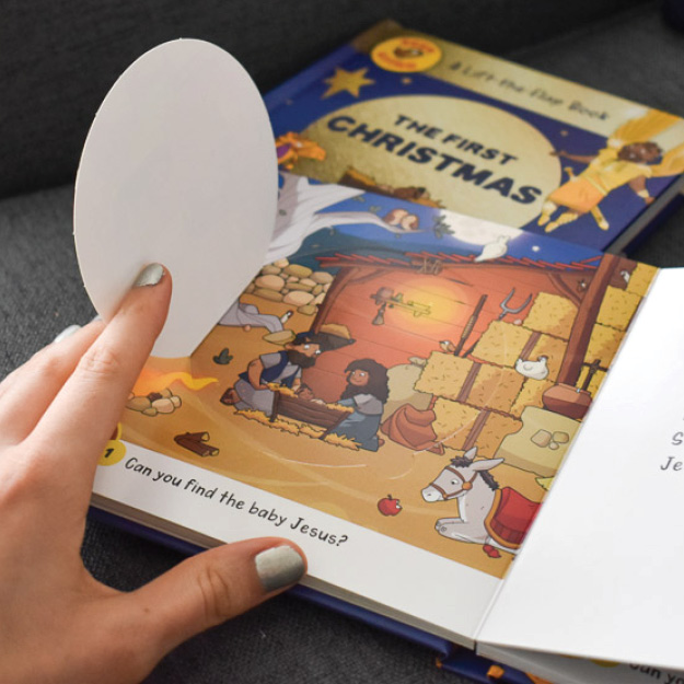 Photograph of someone lifting a flap to reveal Joseph, Mary, and baby Jesus in Seek and Find: The First Christmas Lift-the-Flap