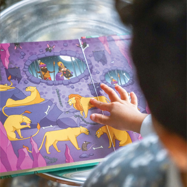 Photograph of child pointing to a lion in Seek and Find: Old Testament